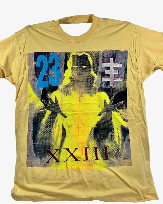 A  yellow short-sleeve Psychic TV graphic t-shirt featuring a stylized print of a glowing yellow figure with the Roman numerals XXIII, the number 23, and a white symbol on a dark background.