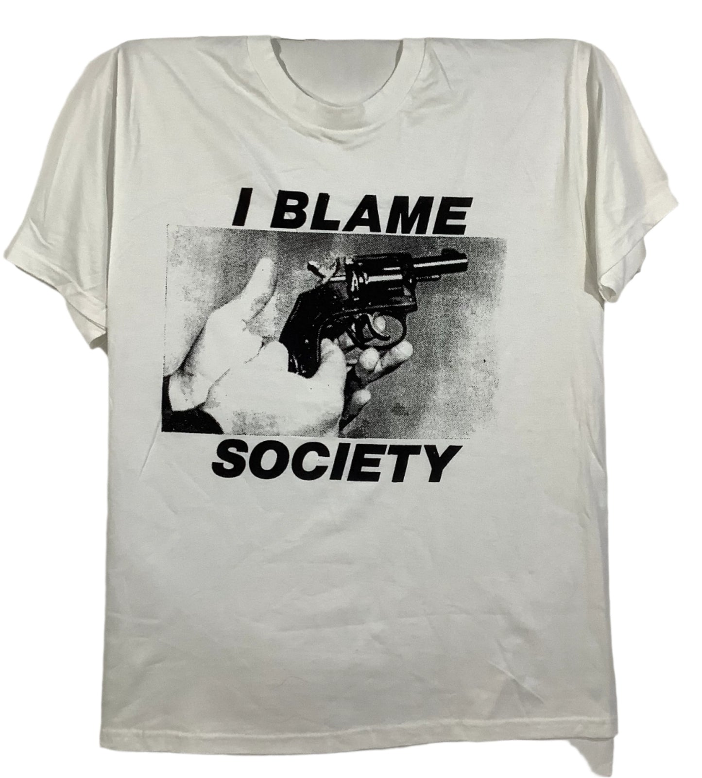 Hand screen printed Blame Society t-shirt on vintage deadstock white cotton, black print reading I BLAME SOCIETY over a hand holding a revolver.